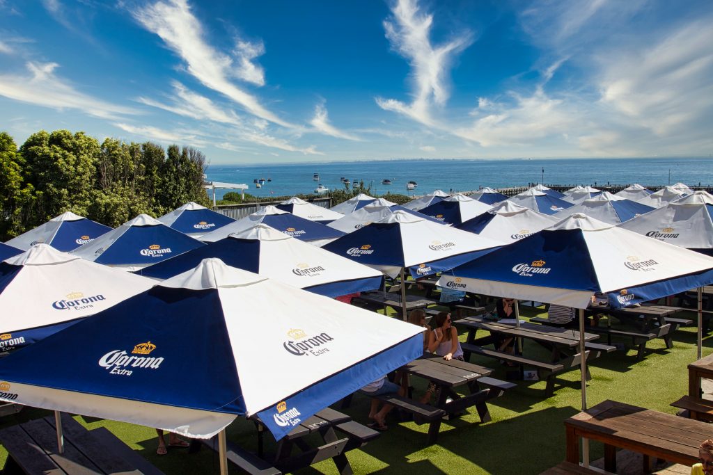 corona branding on market umbrellas for outside dinning space