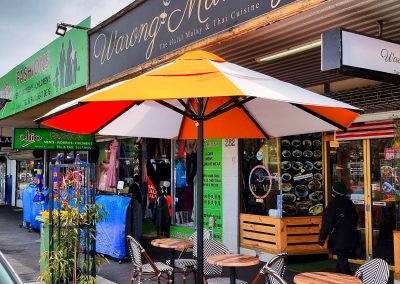 Orange and white striped Ausbrella market umbrellas at City of Great Dandenong (Springvale)